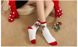 Detailed texture of white coral fleece Christmas socks with festive reindeer pattern