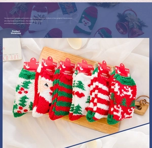 Close-up of six pairs of Christmas coral fleece socks with Santa and reindeer patterns