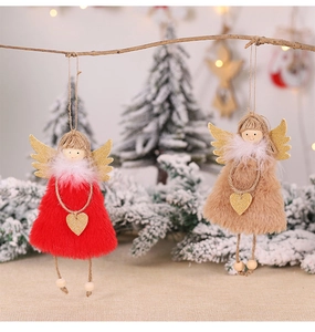 Detailed view of plush Christmas angel ornaments with golden wings on a festive tree