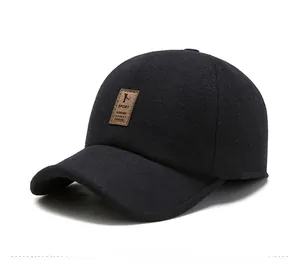Detailed close-up of a black wool baseball cap featuring a brown leather sport patch