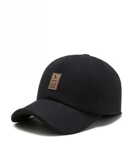 Close-up of black winter wool blend cap featuring a brown leather SPORT patch detail