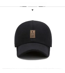 Close-up of black felt winter baseball cap with embossed brown leather sport outdoor patch