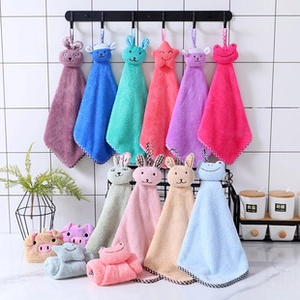 Detail of hanging coral fleece hand towels with cute animal designs and soft textures