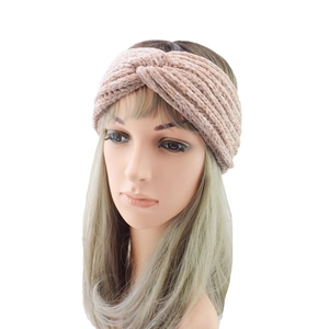 Detail of pink knitted twist headband showing warm chenille texture and soft knot design