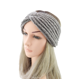 Detail of light grey knit headband featuring a soft chenille twist knot design for winter