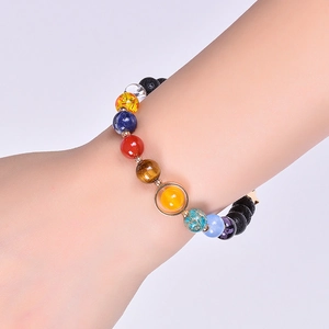 Solar system bracelet with natural stones and volcanic rock beads on a wrist