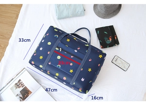 Detail showing the waterproof blue travel bag with cartoon prints and dimensions marks