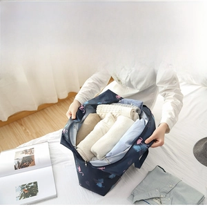 Spacious foldable travel bag with flamingo print packed with clothes for a 6-day trip