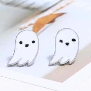 Close-up of ghost-shaped earrings with white enamel finish and silver metal edges