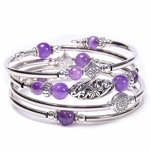Detailed shot of multi-layer wrap bracelet with silver metal tubes and purple beads