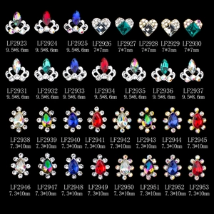 Assorted alloy nail art rhinestones with crown and heart shapes on black background