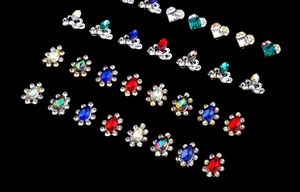 Detailed flat lay of diverse crystal alloy stud earrings in teardrop and floral shapes