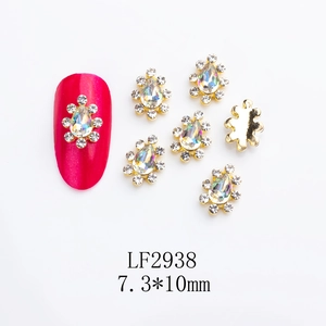 Detailed macro view of gold alloy crown nail charms with pear-shaped rhinestones, 7.3*10mm