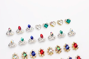 Macro display of crown and heart alloy nail charms with colorful K9 rhinestones