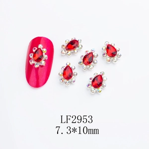 Macro shot of red teardrop nail rhinestones with silver alloy base and colorful AB crystals