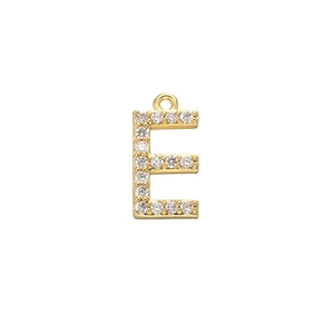 Detailed macro view of gold letter E pendant with micro-pave cubic zirconia stones