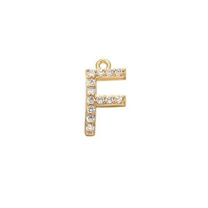 Detailed macro view of golden letter F pendant with micro-pave clear cubic zirconia stones
