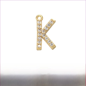 Detailed view of micro-paved zircon letter K pendant in gold-plated brass with dimensions