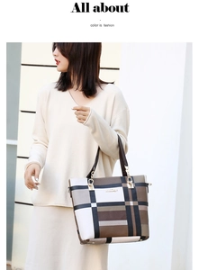 Detail of a large checkered tote bag with golden hardware and textured synthetic leather