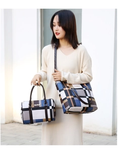 Detail of plaid tote and boston bag set featuring blue and brown checkered pattern