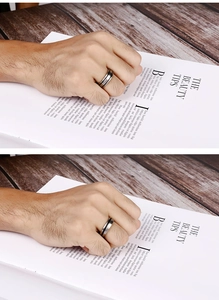 Close-up of minimalist silver steel men's ring with black inlay on a dark wooden table