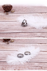 Macro detail of silver stainless steel rings with black inlay and brushed metal texture