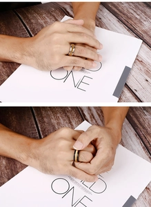 Detail of black and gold brushed titanium steel rings for men on a stylish magazine