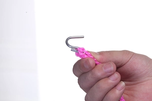 Detail of pink windproof clothesline with durable silver metal hook for outdoor use