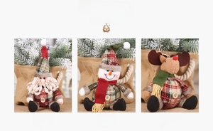 Detailed view of Christmas plush ornaments featuring Santa, Snowman, and Reindeer designs