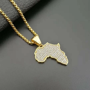 Detailed macro view of gold plated Africa map pendant with inlaid sparkling crystals