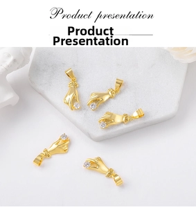 Artistic gold palm pendant charms with clear cubic zirconia in an elegant setup
