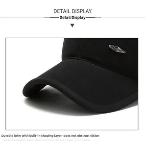 Detail view of the sturdy curved brim and metal fashion emblem on a warm winter baseball cap