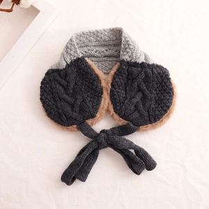 Detail of grey knitted scarf with ear flaps showing soft brown plush lining and braided texture