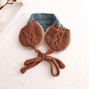 Detail view of knitted earmuff scarf set with brown cable knit and plush lining
