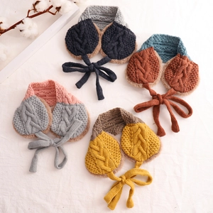 Flat lay of colorful knit scarves with plush earmuffs in four different color combinations