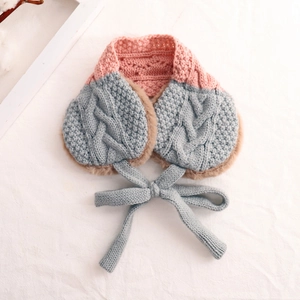 Detail of blue and pink knit scarf with soft plush lining and cute bow tie for kids