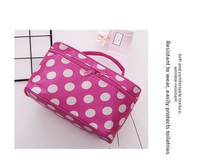 Pink polka dot makeup bag with handle and double zipper closure for toiletries