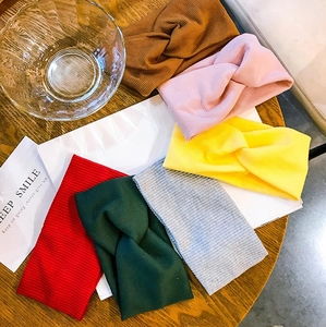 Detailed view of six colorful ribbed knit headbands with stylish twisted knot design