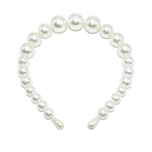 Detailed view of large gradient white pearls on a bridal headband with teardrop ends