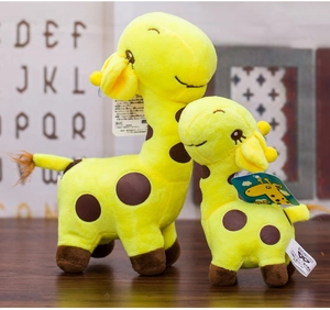Close-up of a large and small spotted giraffe plush set with embroidered eyes and tags