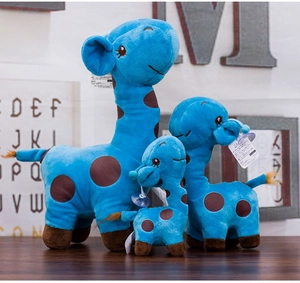 Three sizes of blue plush giraffe toys with brown spots and product tags in a cozy setting