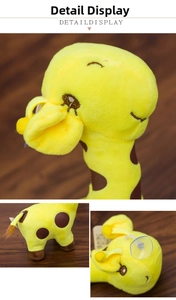 Close-up of yellow giraffe plush toy with embroidery details and suction cup attachment