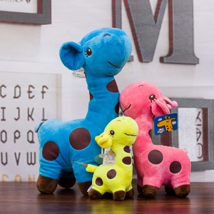Three colorful plush giraffes in blue, pink, and yellow displayed in a cozy nursery setting