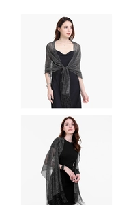 Detail of elegant black evening shawl with silver shimmer and fringe tassel finishes