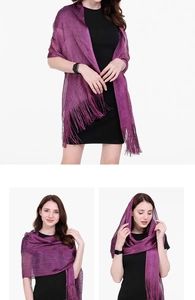 Detailed view of the shimmering purple shawl featuring long fringe tassels and high luster fabric