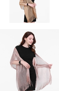 Close-up of elegant gold and pink evening shawls featuring delicate fringe tassels