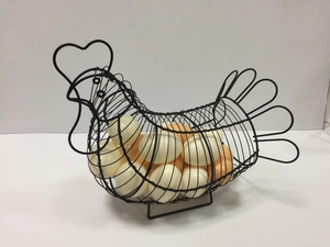 Detail showing a black hen-shaped wire egg basket filled with fresh white and brown eggs
