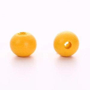Close-up of vibrant yellow round wooden beads with smooth finish for DIY jewelry crafts