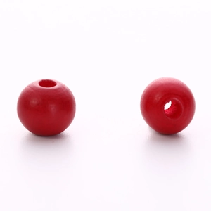 Close-up of vibrant red round wooden craft beads with central hole for DIY jewelry