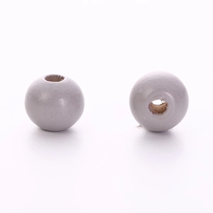 Detailed macro view of two light grey wooden round beads with drill holes for DIY jewelry
